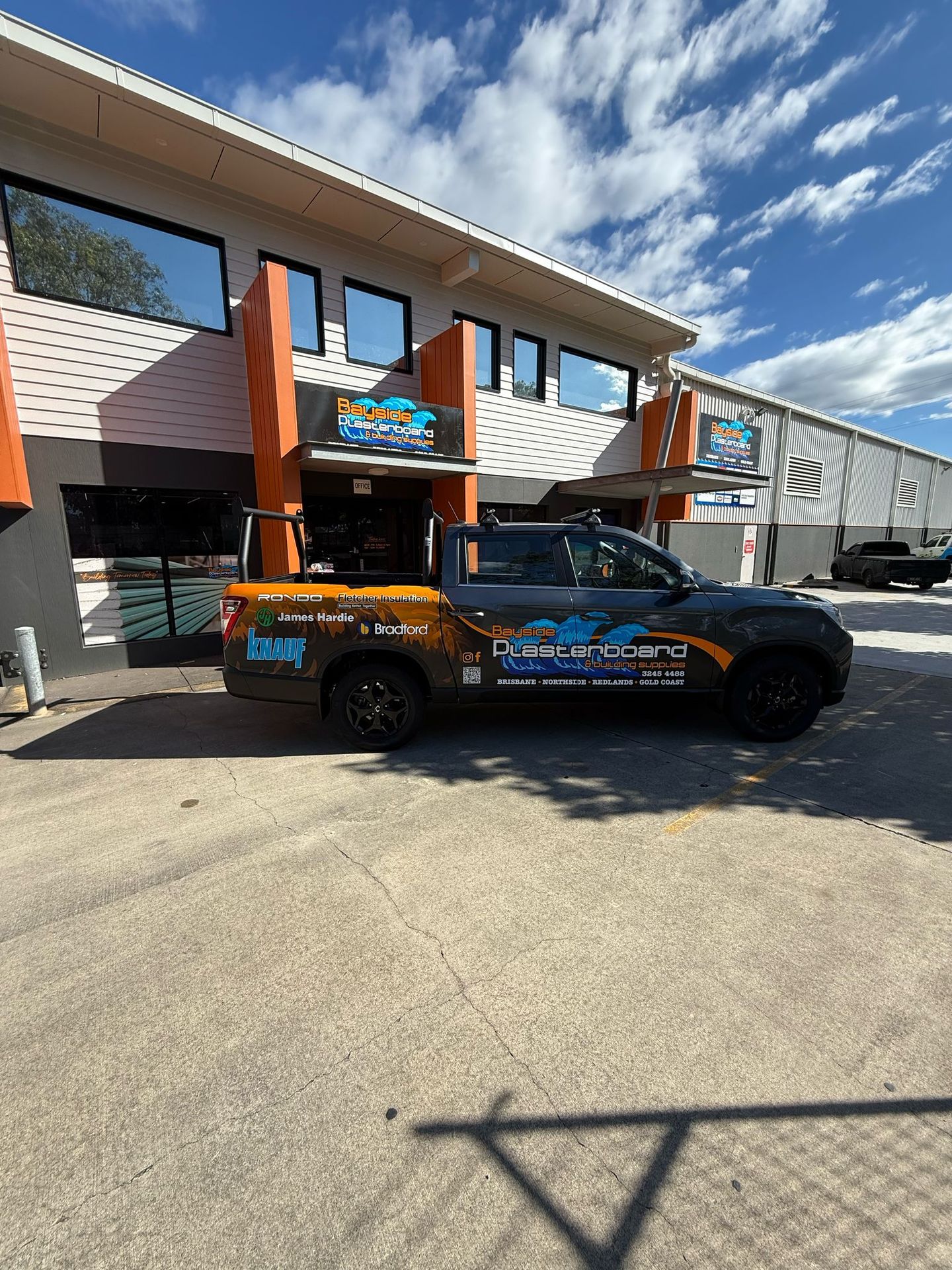 Bayside Plasterboard wrapped dual-cab ute (Rondo, James Hardie, Knauf, Bradford, Fletcher Insulation logos; Brisbane, No