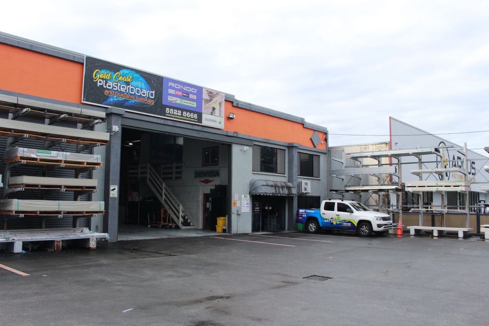 Gold Coast Plasterboard store front with the Showroom entrance, a Bayside Plasterboard branded ute parked in front and c