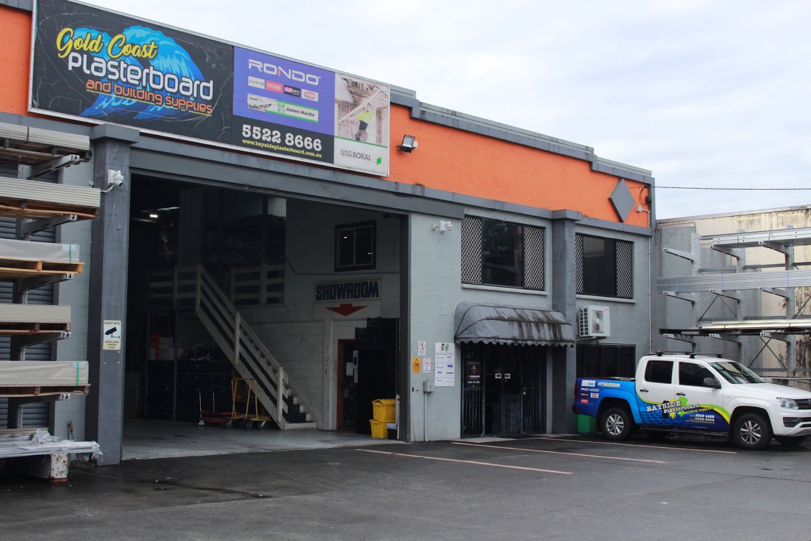 Closer view of the Gold Coast Plasterboard signage, the Showroom entrance stairs and a Bayside Plasterboard wrapped ute