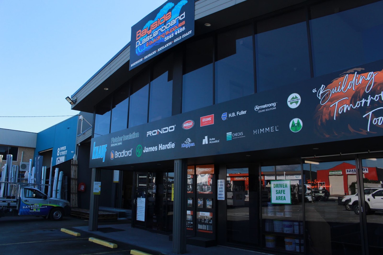 Northside store front with the supplier logo strip including Knauf, Rondo, Bradford and James Hardie